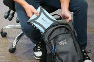 Pico PicoScope 5000E Series scope being placed in rucksack (not included)